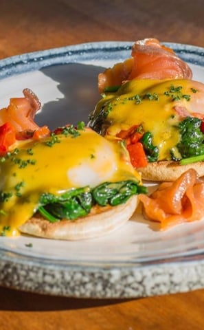 a plate of food with eggs and cheese on it