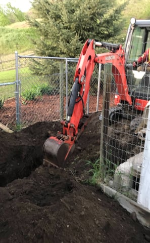 Using a mini-excavator to install deep utilities in Vernon BC