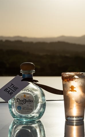 a bottle of tequila in a glass with a bottle of tequila
