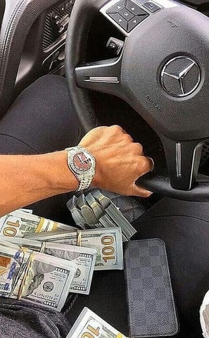 a man driving a car with money