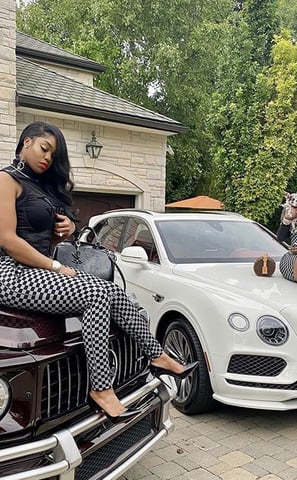 a woman sitting on a car with a woman sitting on the hood of a car