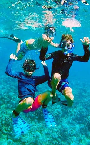 a group of people in scuba gear in the water