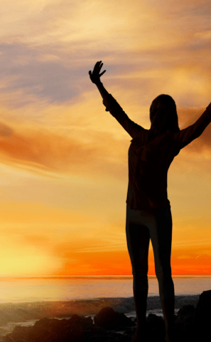 A woman walking towards a clear horizon can represent the journey towards a full and balanced life.
