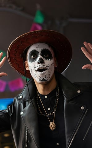 a man in a black leather jacket and a white face paint on his face
