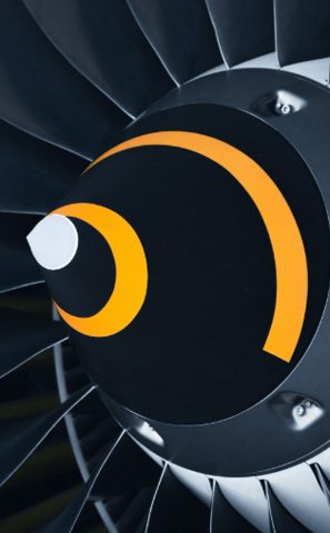 Close-up view of an airplane turbine engine, showcasing the intricate metal blades within the engine