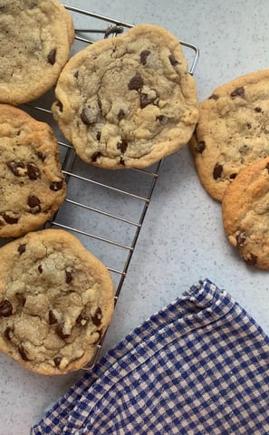 freshly baked sugar cookies displayed before a farmers market selling assorted baked goods