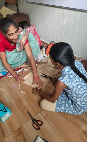 teacher sewing w young girl