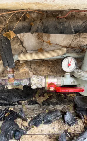 a pipe with a red valve and a pipe with a red valve
