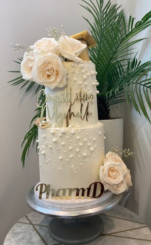 a cake with a white cake topperf and flowers