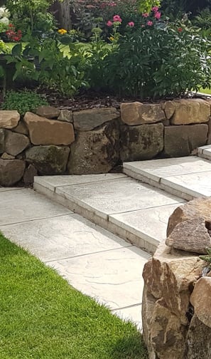 Rockery stone retaining wall with concrete steps and new lawn in Wroxham