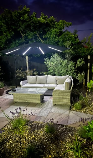Garden seating area on a sandstone patio, surrounded by mature planting in hemsby