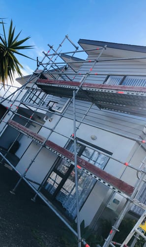 a house with scaffiered scaffolding on the roof