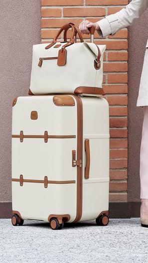 a woman in a white coat with a travel luggage and travel bags