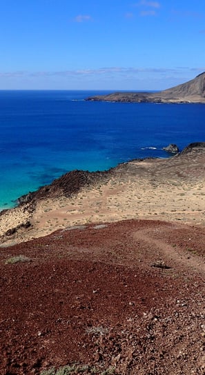 a woman walking up a volcano