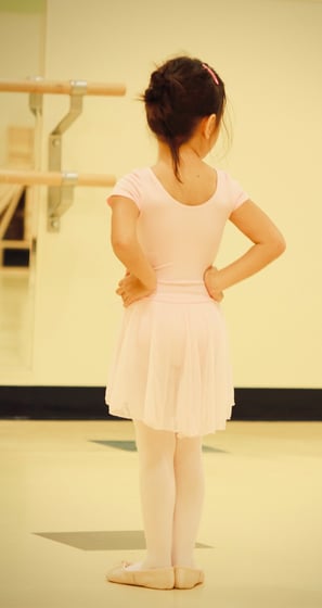 A young girl in a ballet outfit