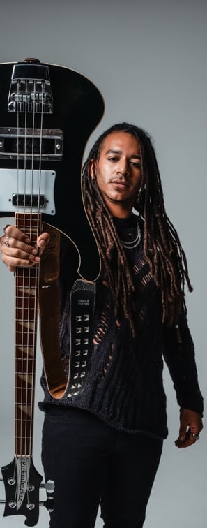 a bass player with dreadlocks and a bass