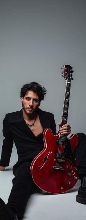 a guitar player in a suit and a guitar