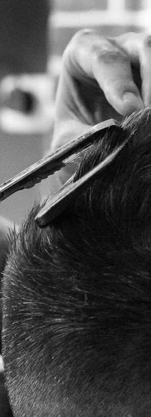 a man is cutting his hair with scissors and scissors