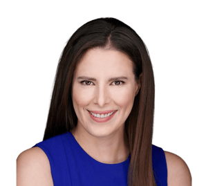 a pretty woman with brown hair and brown eyes in a blue dress smiling at the camera.