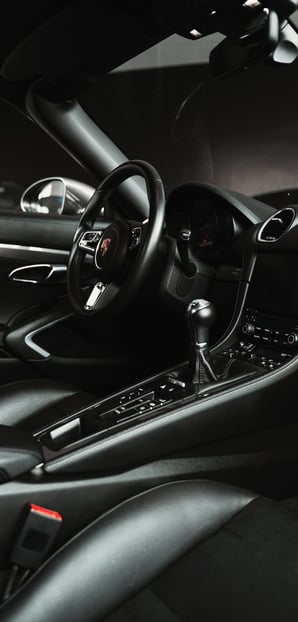 a car dashboard with a steering wheel and dashboard controls