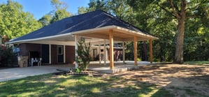 Covered outdoor patio area with hip roof.