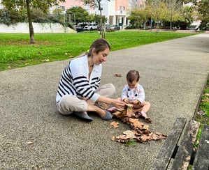 a woman sitting on a bench with a baby