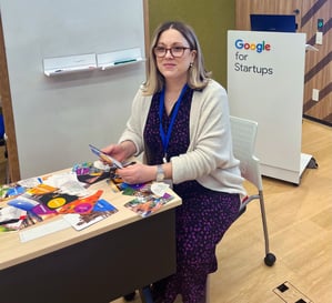 Julie Gachet Mitrovic sitting at a table with Strengths cards for a workshop at Google for Startups
