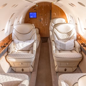 Hawker 800XP cabin interior with luxury leather seating and ambient lighting