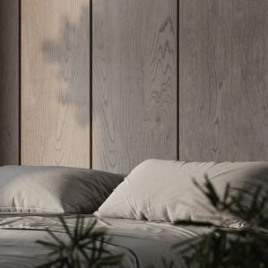 3D rendering of a modern bedroom with a grey bed, wood panel wall, plants, and concrete floor in a minimal design.