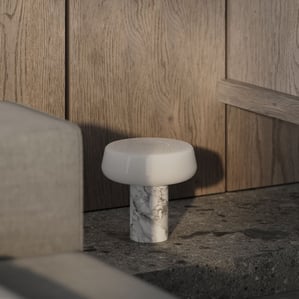 3D interior rendering of a modern lamp with marble base on a stone table, framed by wooden wall panels with natural grain.