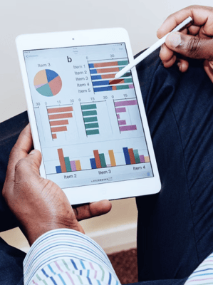 a man holding a tablet computer and a pen