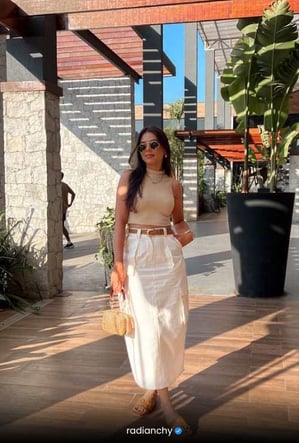 a woman in a white dress and sunglasses