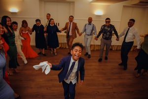 Child dancing and smiling at a Wedding in Fátima