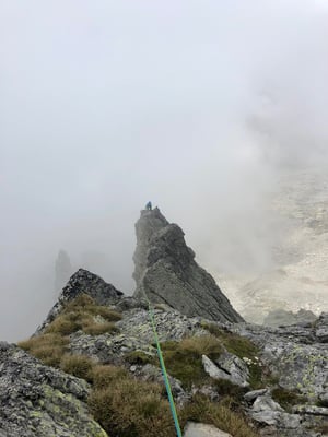 Climbing on Spigolo Gervasutti with classic Masino afternoon clouds