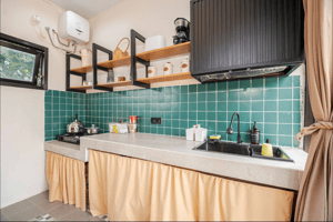 Fully equipped kitchen with modern appliances, countertops, and storage.