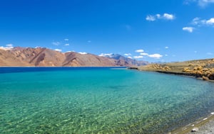 a beach with a mountain in the background