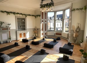 a room with a lot of yoga mats and a fireplace