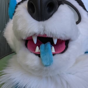This is blue a dog fursuit made by Teto creations with blue ears and black fur on his face