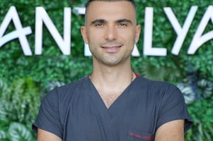 a man in a gray shirt and a watch on his wrist