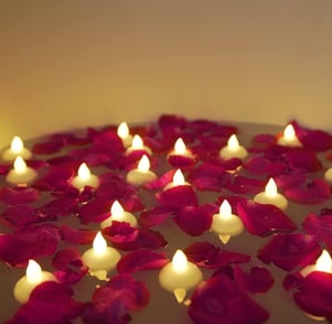 a bowl of candles with candles on a table