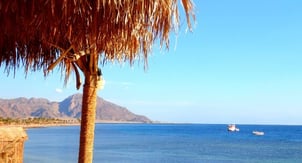 a boat in the water near a beach in Egypt