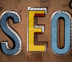 a wooden sign that says seo is a great way to improve your search engine
