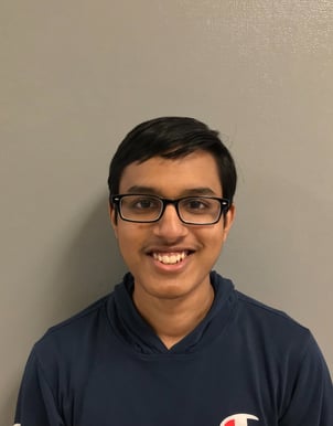 Headshot of a young man wearing glasses