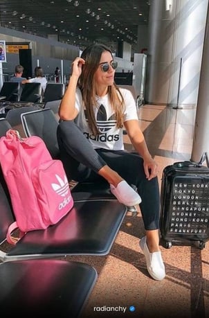 a woman sitting on a bench in an airport