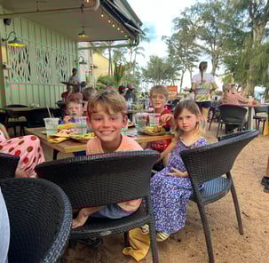 Kids dinning on a beachfront restuarant