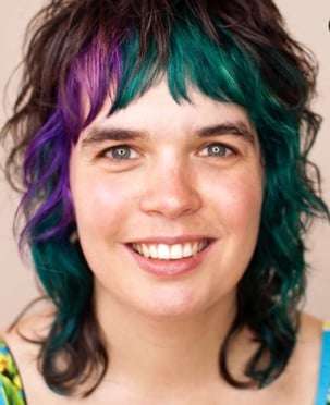 person with black, purple and green hair