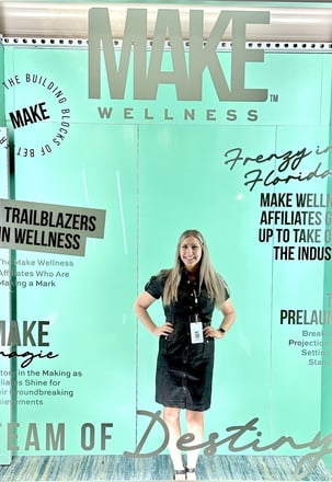 Woman posing with Make Wellness Magazine cover
