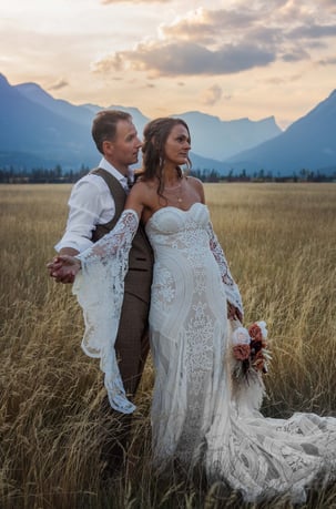 a bride and groom standing in a field in Jasper