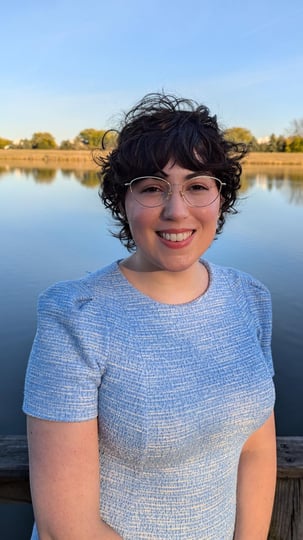 A picture of Rae O'Connor standing in front of a pond