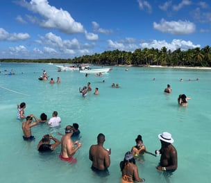 a group of people in the water at a beach
